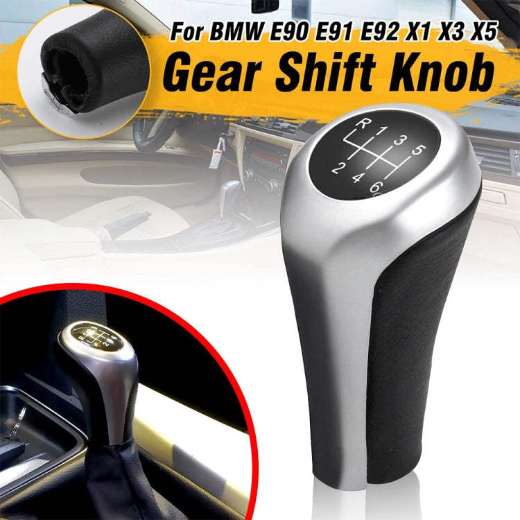 Matte silver 6-speed gear shift knob with black leather grip and top-mounted shift indicator