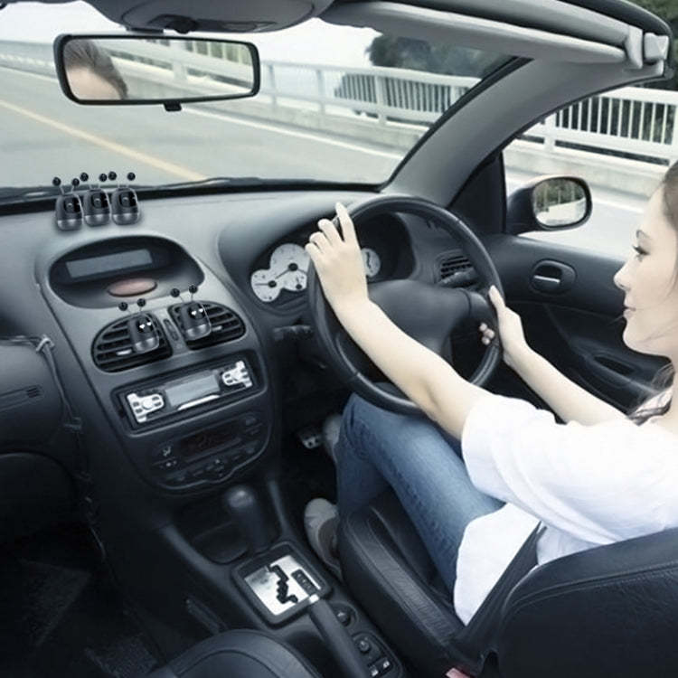 Black robot car aromatherapy dispenser on the dashboard, viewed from driver seat