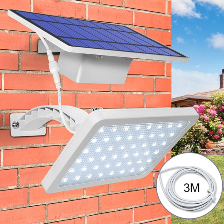 White solar street lamp with blue solar panel and LED light mounted on a wall