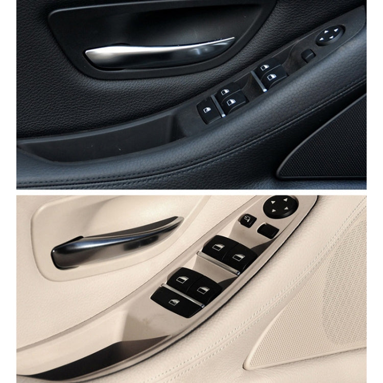Left front inner door armrest with handle and power window switches, black and beige