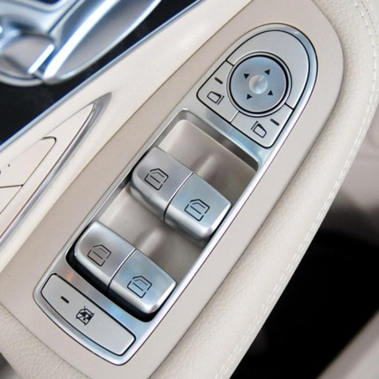 Car door window switch panel with silver buttons in beige trim