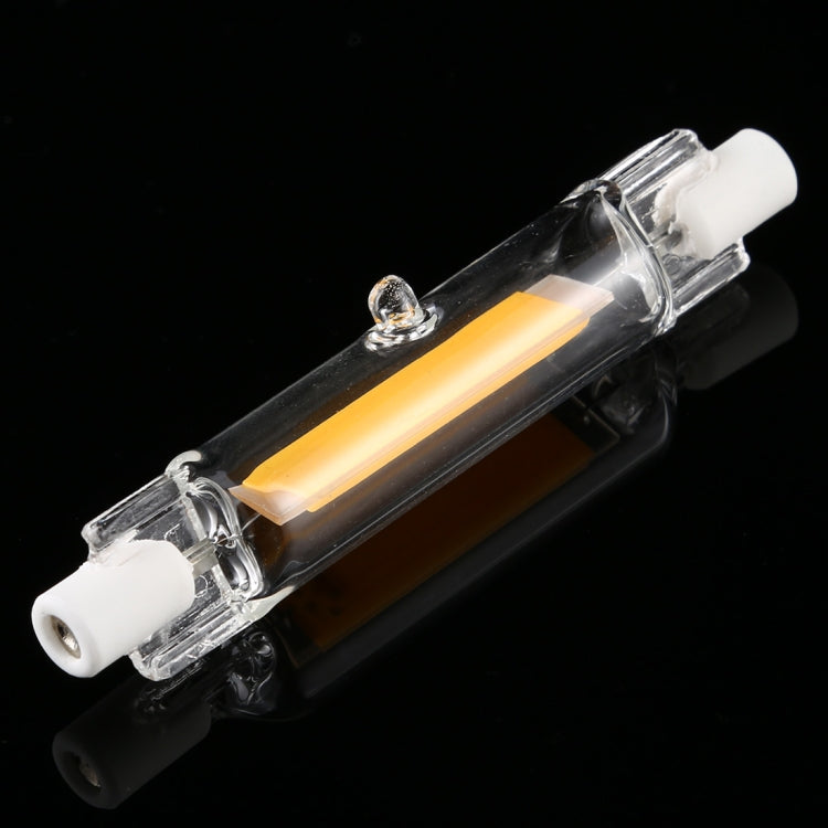 Angled view of linear R7S LED bulb with clear glass tube and amber LED strip