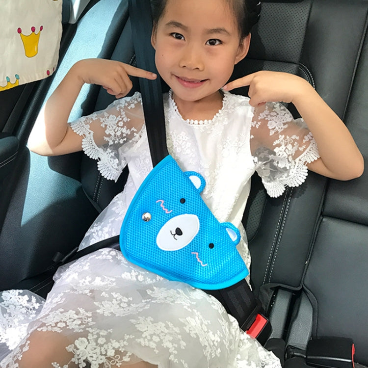 Kid in car holding a blue bear-faced seat belt shoulder cover with button eyes