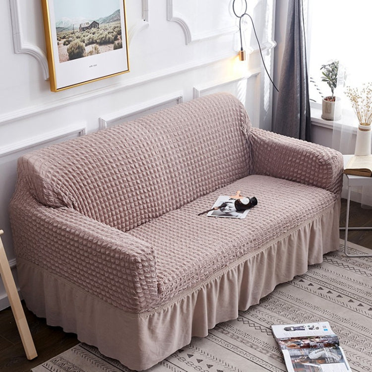 Light beige stretch sofa cover with textured waffle fabric and ruffled skirt hem