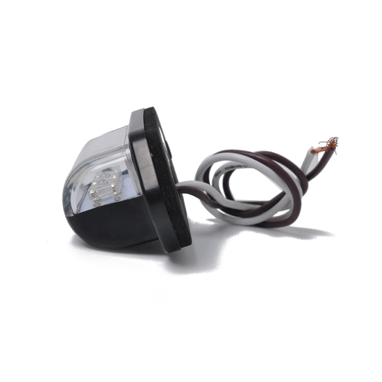 Round-corner end view of black license plate LED light with clear lens and 3 LEDs