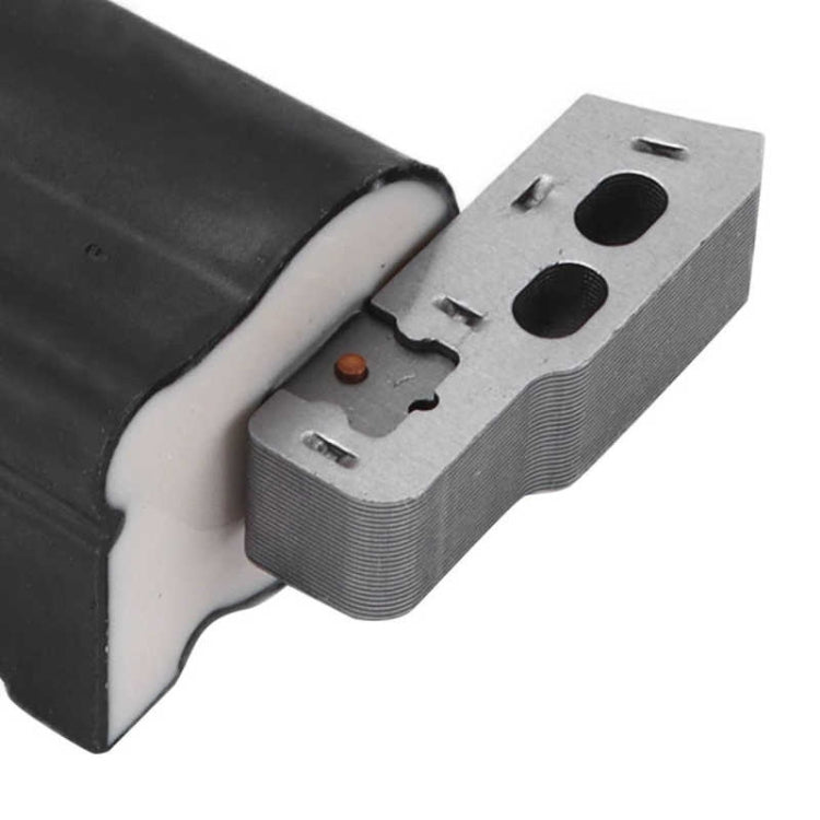 Close-up ignition coil terminal block with orange contact on metal plate