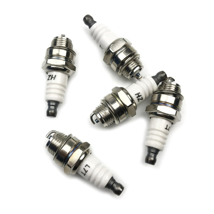Assorted spark plugs with white ceramic insulators, chrome caps, and black electrode tips