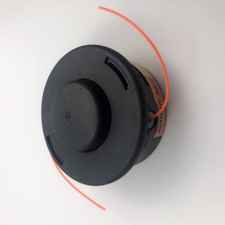 Black plastic trimmer head with orange cutting line, side view