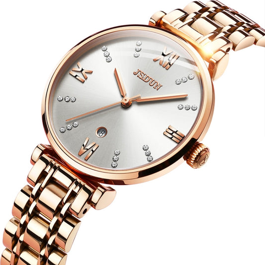 Women’s rose-gold quartz watch close-up with white dial, Roman numerals, and jeweled accents.