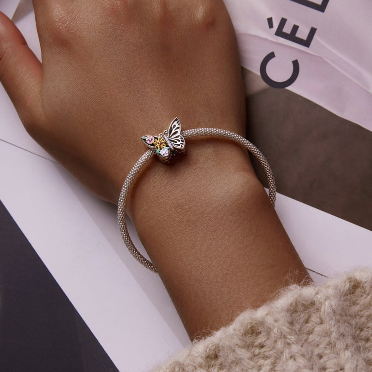 Butterfly flower charm mesh bracelet worn on wrist, sterling silver with enamel accents