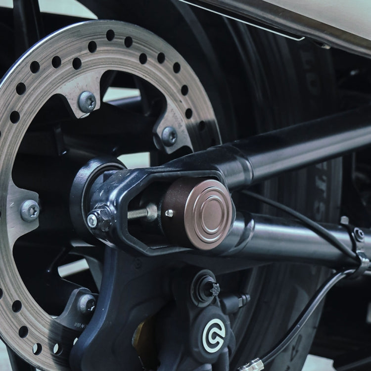 Motorcycle rear axle nut cover cap installed near wheel hub, bronze round domed cap