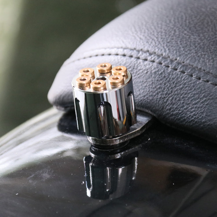Gold cap nuts on black motorcycle seat mounting screw attached to dark leather