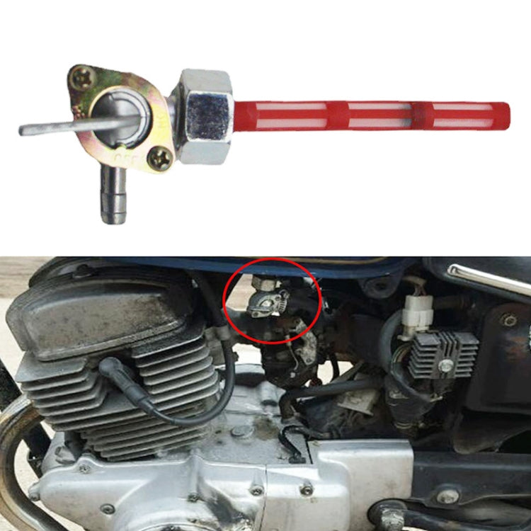 Motorcycle fuel petcock valve installed on engine, red lever and brass body