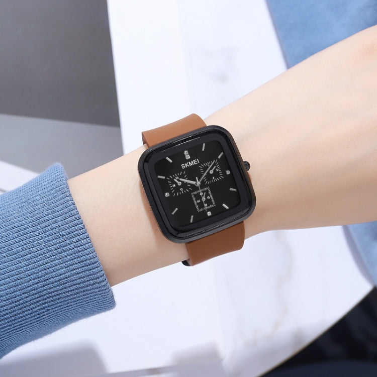 SKMEI square silicone quartz watch on wrist, black dial, tan/brown strap