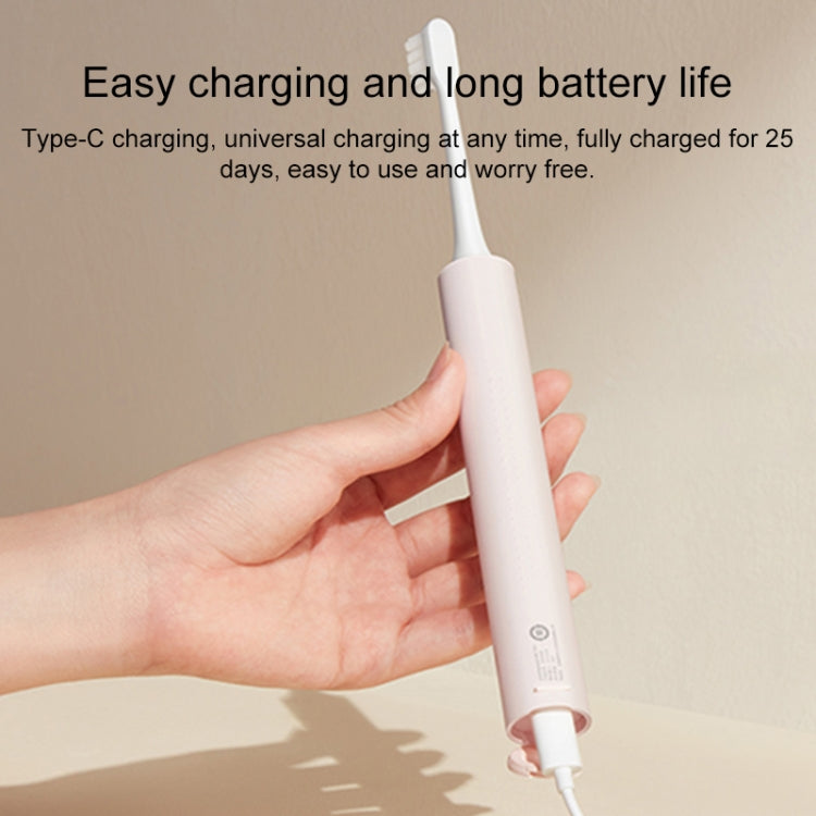 White electric toothbrush charging with Type-C cable held in a hand