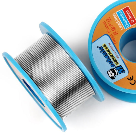 Silver solder wire wound on spool beside blue lead-free rosin core tin, 0.3mm