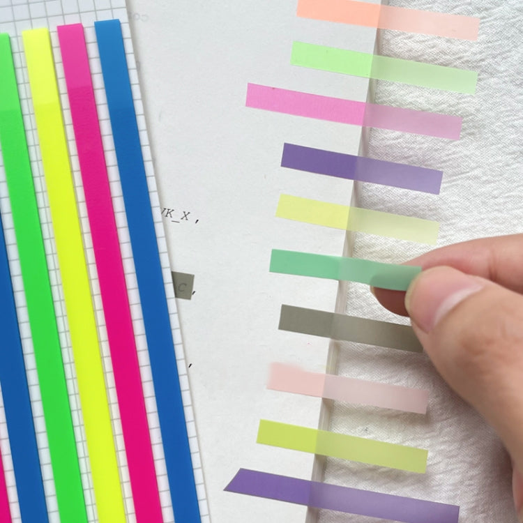 Hand applying fluorescent strip sticky notes in pink, purple, green, and blue colors