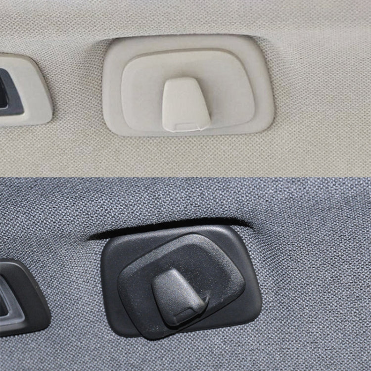 Beige and black car coat hook hangers on fabric panel, left-drive style