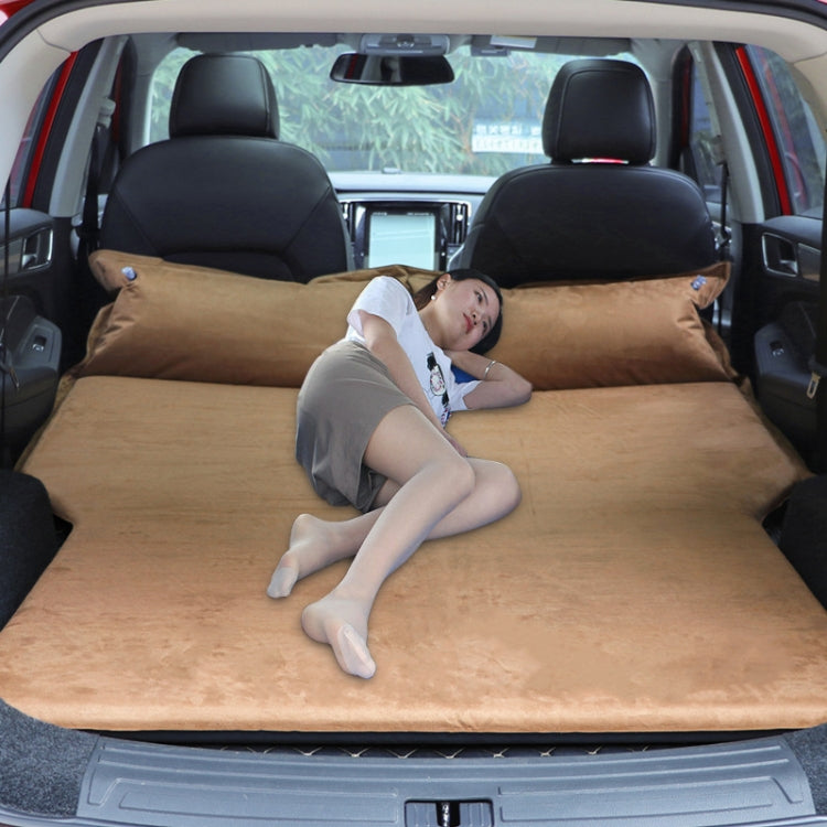 Brown inflatable car sleeping mat mattress in SUV trunk, person reclining on top