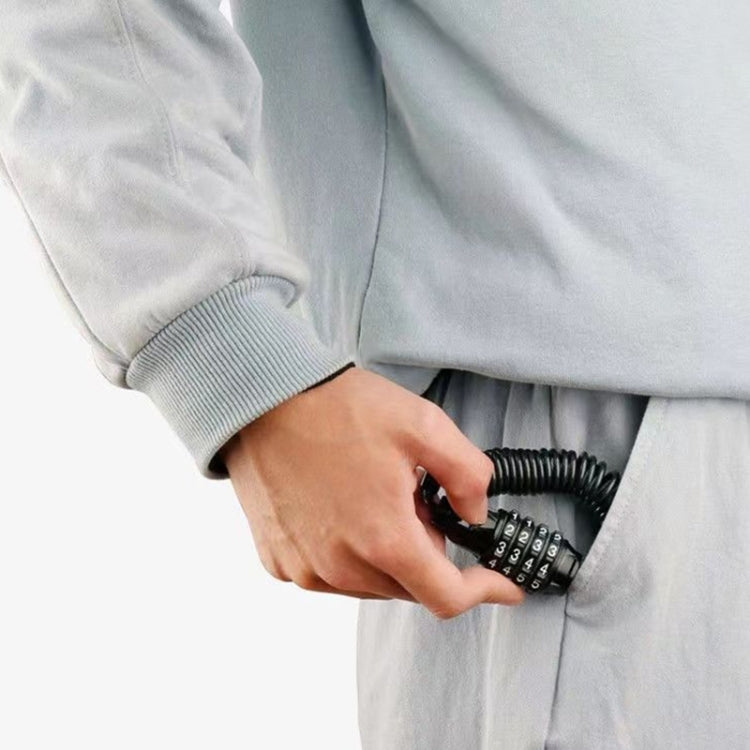 Hand operating a 4-digit bicycle cable combination lock