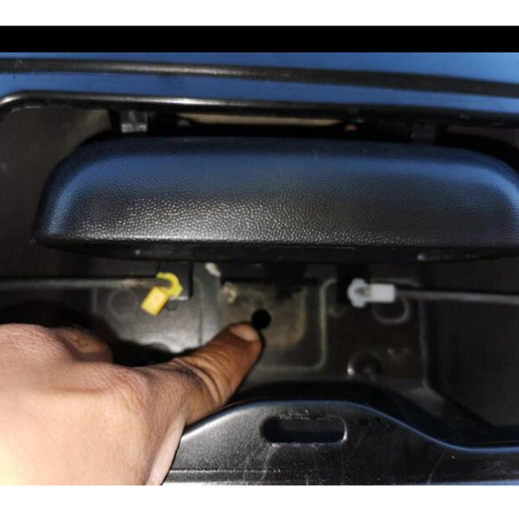 Car tailgate handle installation showing hand installing the handle near latch opening