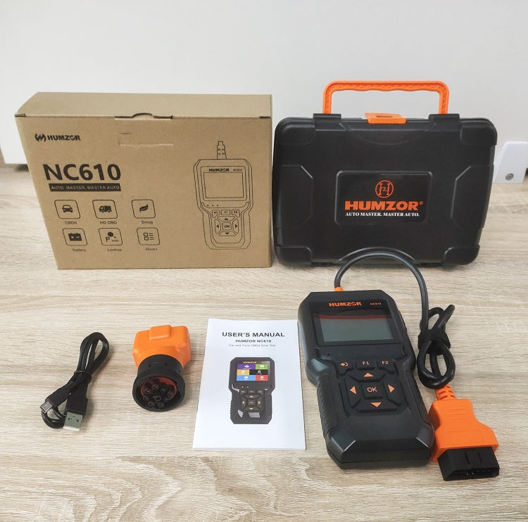 Orange and black OBD2 code reader with display, case, cables, and user manual