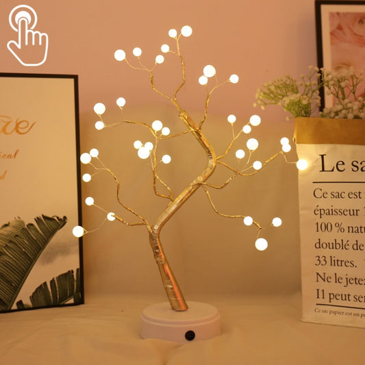 Copper wire pearl tree table lamp with warm white LED lights on a white base