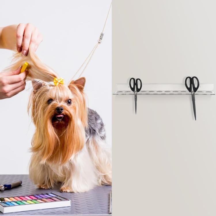 Acrylic scissors wall mount bracket with multiple scissors mounted on it.