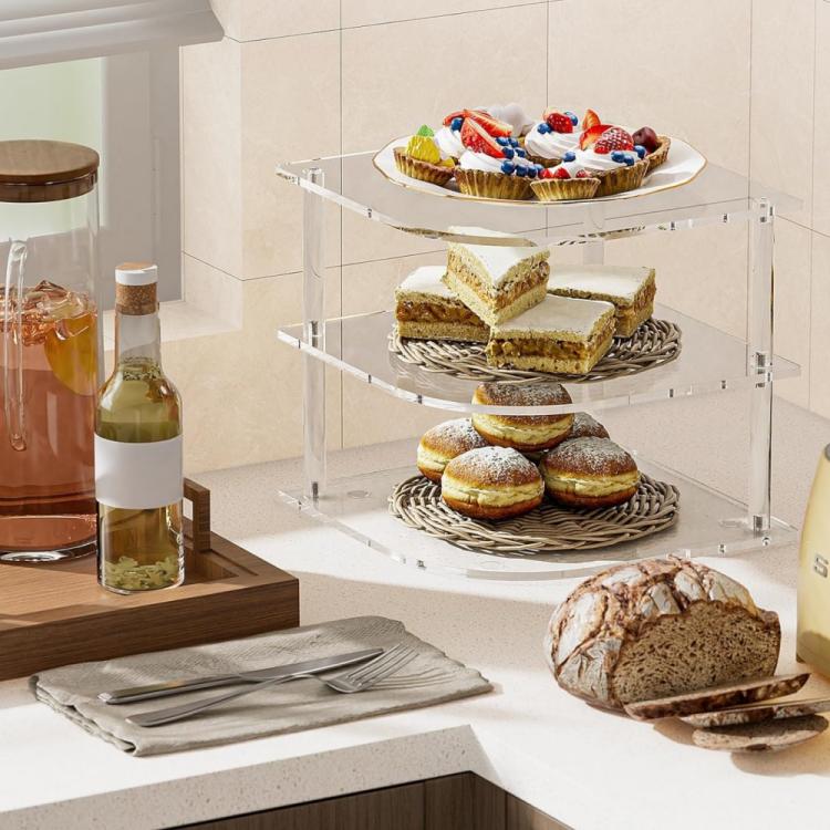 Clear corner 3-tier acrylic shelf with cake slices, donuts, and bread