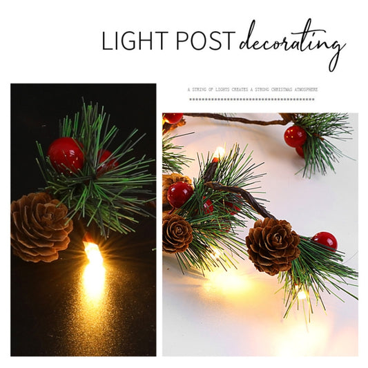 Decorative light string on pine branch with red balls and pine cones, warm glow