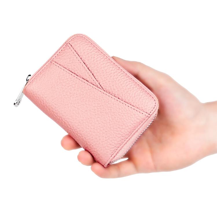 Pink leather coin card bag held in hand with zip closure