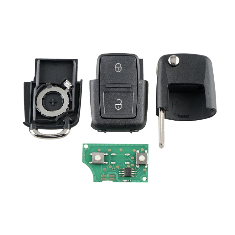 Car key fob parts laid out: shell halves, button cover, metal key blade, circuit board