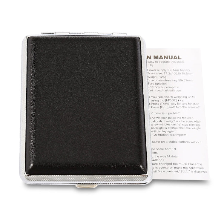 Digital jewelry scale with black underside cover and instruction label inside open case