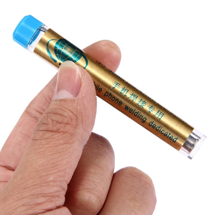 Hand holding blue-capped solder wire tube; flux-core solder wire visible