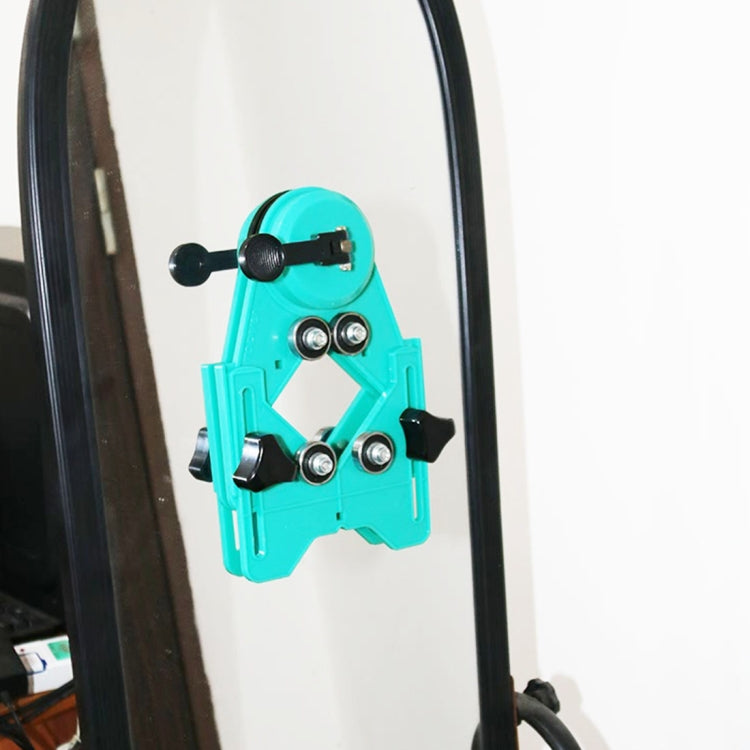 Turquoise suction tile drill locator jig mounted on glass panel with guide cups