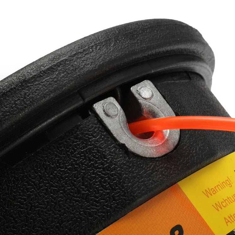 Black trimmer head close-up with orange cutting line and metal latch