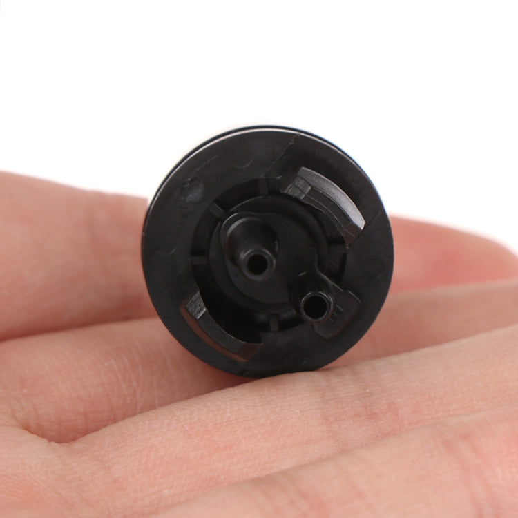 Carburetor primer bulb snap-in base, black circular underside with ports