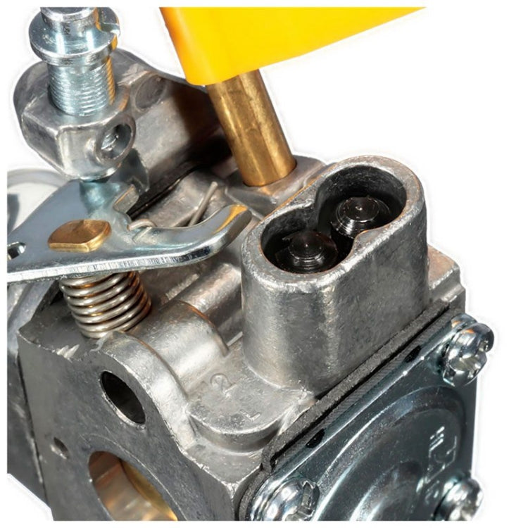 Carburetor close-up with metal ports and linkages, showing black capped openings