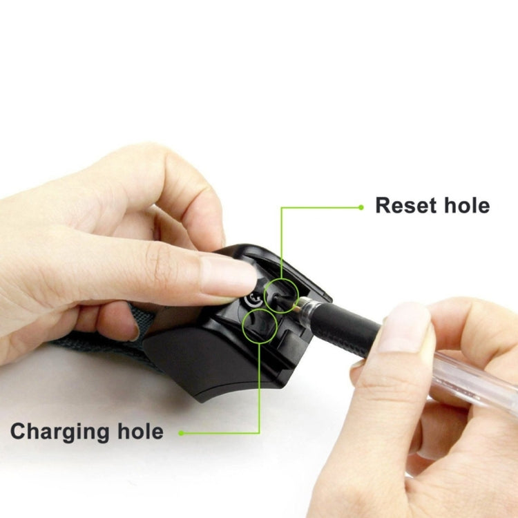 Handheld remote with charging hole and reset hole on black transmitter