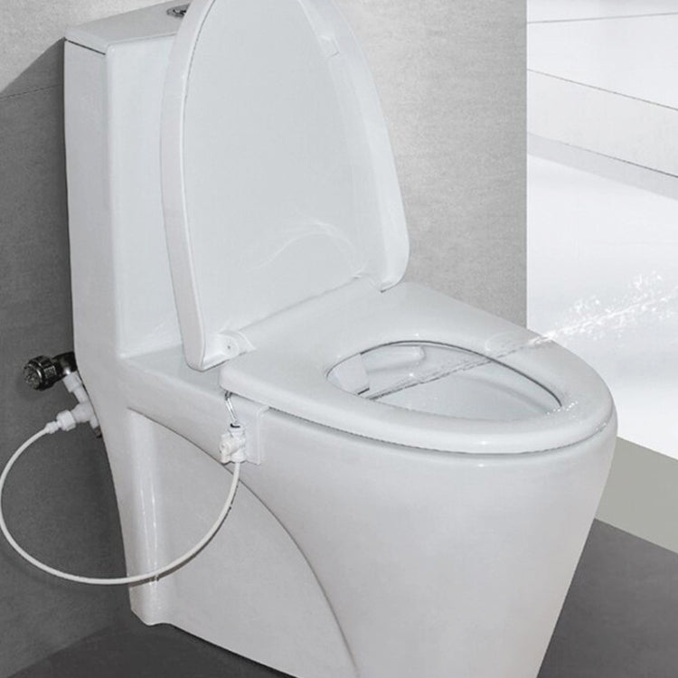 Installed toilet bidet water spray seat tool on toilet seat with connected hose