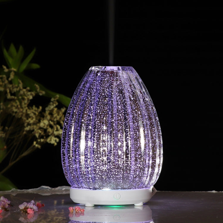 Purple glitter glass LED humidifier vase shape with white base and glowing light