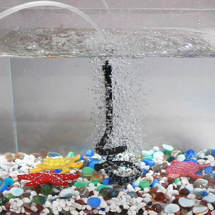 Single aquarium diffuser nozzle releasing bubbles from black air hose
