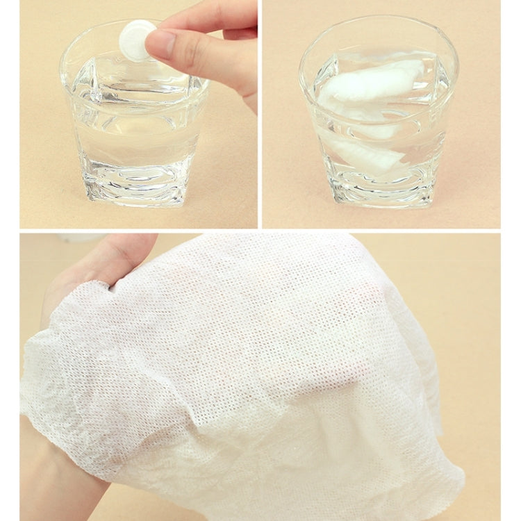 White disposable cotton towel sheet for travel use, shown with water glass