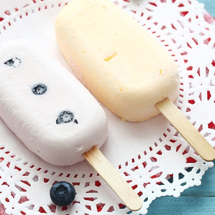 White ice-cream bar treats with wooden spatula sticks and blueberries