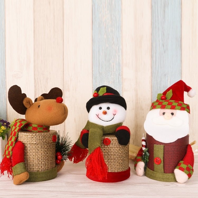Linen snowman candy jar with green outfit and black top hat, displayed with holiday figures