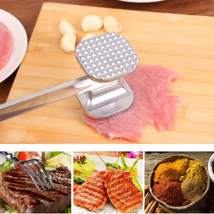 Aluminum meat tenderizer hammer with textured head resting on sliced meat