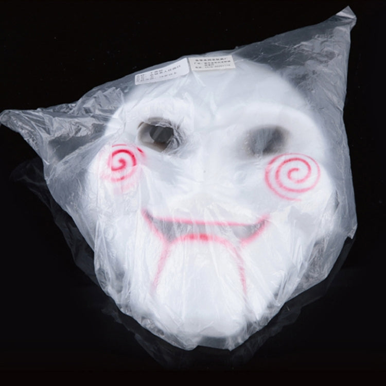 White skull Halloween mask in clear plastic bag, red spiral cheeks visible