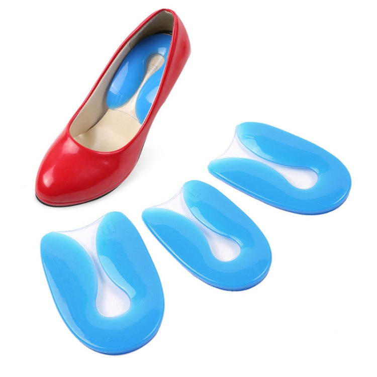 Blue silicone U-shaped heel pad inserts with pair shown near a red shoe