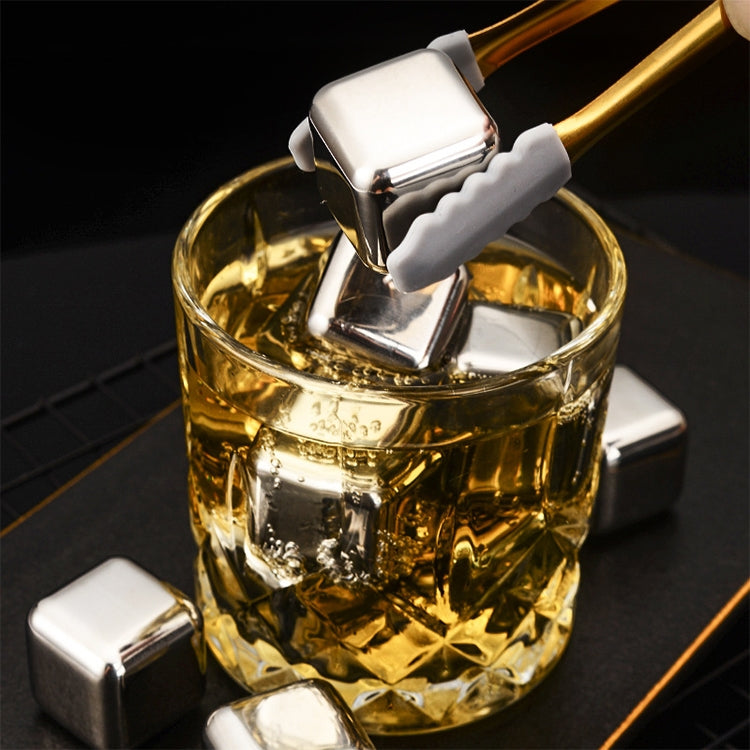Reusable stainless steel ice cubes floating in an amber drink