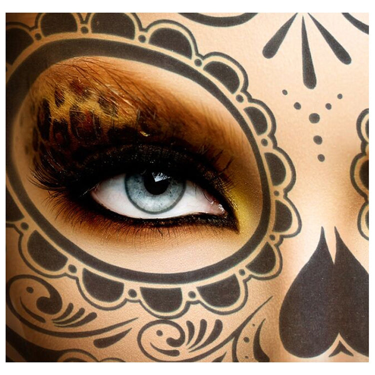 Temporary face tattoo sticker with close-up eye and ornate face art in brown and black